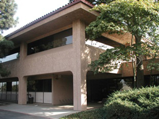 Corona Courthouse framed by manicured trees and bushes